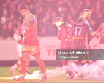 Bohemian FC goalkeeper Kacper Chorazka watches as Flares interrupt the SSE Airtricity Men's Premier Division match between Bohemian FC and St. Patrick's Athletic FC at Richmond Park, Dublin on Feb. 23, 2024
