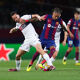Raphinha of FC Barcelona is challenged by Fabian Ruiz of Paris Saint-Germain during the UEFA Champions League quarter-final second leg match between FC Barcelona and Paris Saint-Germain at Estadi Olimpic Lluis Companys on April 16, 2024 in Barcelona