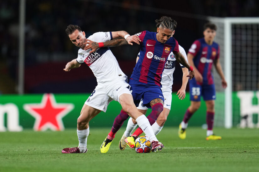 Raphinha of FC Barcelona is challenged by Fabian Ruiz of Paris Saint-Germain during the UEFA Champions League quarter-final second leg match between FC Barcelona and Paris Saint-Germain at Estadi Olimpic Lluis Companys on April 16, 2024 in Barcelona