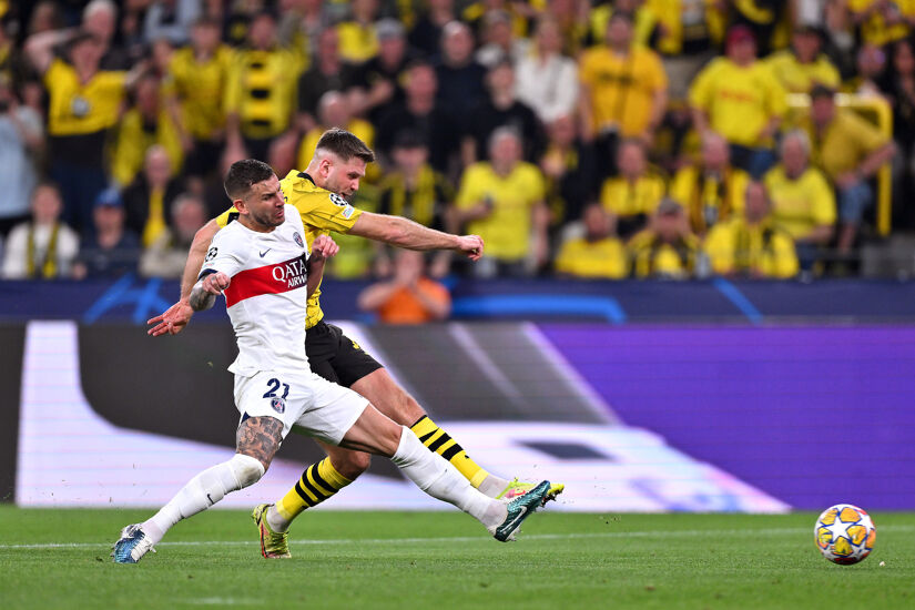 Niclas Fuellkrug of Borussia Dortmund scores his team's first goal whilst under pressure from Lucas Hernandez of Paris Saint-Germain during the UEFA Champions League semi-final first leg match