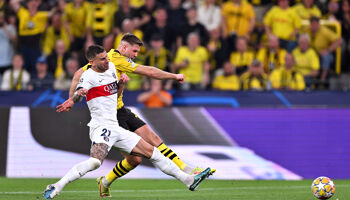 Niclas Fuellkrug of Borussia Dortmund scores his team's first goal whilst under pressure from Lucas Hernandez of Paris Saint-Germain during the UEFA Champions League semi-final first leg match