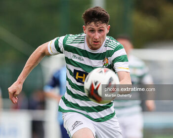 Christy McLoughlin of Cockhill Celtic keeps his eyes on the ball against ST Mochta's in an FAI Intermediate Cup game in 2021