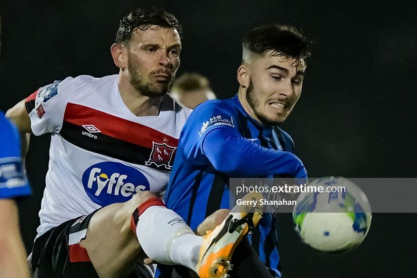 Dundalk's Andy Boyle competes for the ball with Athlone Town's Ronan Manning.