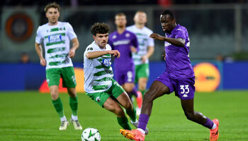 Michael Kayode of Fiorentina runs with the ball under pressure from Ben Clark of The New Saints during the UEFA Conference League 2024/25 League Phase MD1 match between ACF Fiorentina and The New Saints FC at  on October 03, 2024 in Florence, Italy.