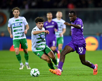 Michael Kayode of Fiorentina runs with the ball under pressure from Ben Clark of The New Saints during the UEFA Conference League 2024/25 League Phase MD1 match between ACF Fiorentina and The New Saints FC at  on October 03, 2024 in Florence, Italy.