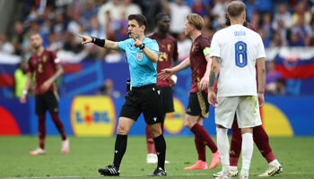 Referee Umut Meler, who will officiate England v Slovakia, gestures as he disallows the goal scored by Romelu Lukaku of Belgium after a handball decision via a VAR Review, during the EURO 2024 group stage match between Belgium and Slovakia in Frankfurt