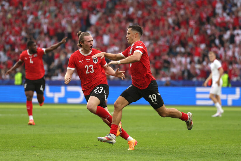 Christoph Baumgartner of Austria celebrates scoring his team's second goal with teammate Patrick Wimmer during the UEFA EURO 2024 group stage match between Poland and Austria at Olympiastadion on June 21, 2024 in Berlin