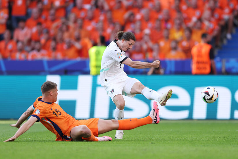 Marcel Sabitzer of Austria scores his team's third goal whilst under pressure from Micky van de Ven of the Netherlands during the UEFA EURO 2024 group stage match between Netherlands and Austria at Olympiastadion on June 25, 2024 in Berlin