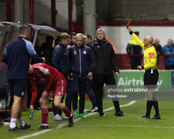 Neil Doyle brandishes a red card.
