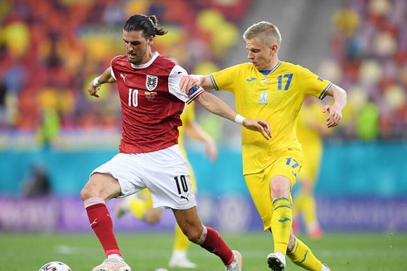  Florian Grillitsch of Austria battles for possession with Oleksandr Zinchenko of Ukraine during the UEFA Euro 2020 Championship Group C match between Ukraine and Austria at National Arena on June 21, 2021 in Bucharest, Romania