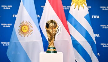 A view of the FIFA World Cup Winner's Trophy with the flags of the hosts of the matches of the FIFA World Cup 2030 Centenary Celebration Uruguay, Argentina and Paraguay during a trophy shoot at the Home of FIFA on December 11, 2024 in Zurich