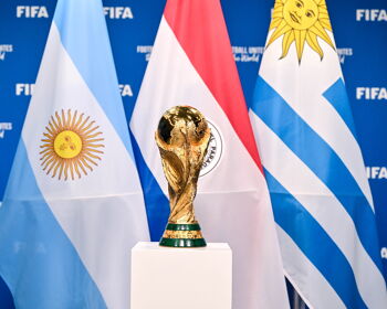 A view of the FIFA World Cup Winner's Trophy with the flags of the hosts of the matches of the FIFA World Cup 2030 Centenary Celebration Uruguay, Argentina and Paraguay during a trophy shoot at the Home of FIFA on December 11, 2024 in Zurich