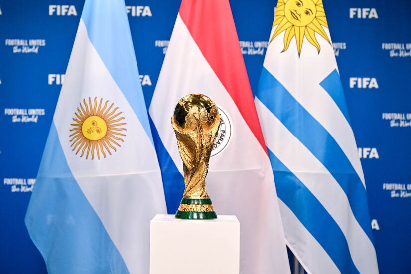 A view of the FIFA World Cup Winner's Trophy with the flags of the hosts of the matches of the FIFA World Cup 2030 Centenary Celebration Uruguay, Argentina and Paraguay during a trophy shoot at the Home of FIFA on December 11, 2024 in Zurich