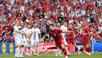 MUNICH, GERMANY - JUNE 20: Luka Jovic of Serbia celebrates scoring his team's first goal as players of Slovenia react during the UEFA EURO 2024 group stage match between Slovenia and Serbia at Munich Football Arena on June 20, 2024 in Munich, Germany.