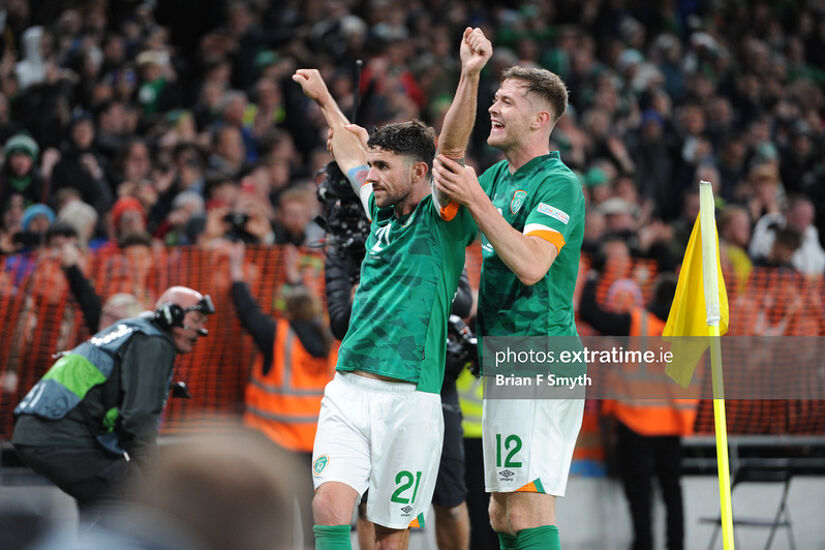 Robbie Brady celebrates with Nathan Collins after scoring the winning goal