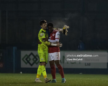 Mark McGinley and Tunde Owalabi embrace at the final whistle in Finn Park when the sides met in March