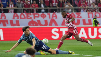Ayoub El Kaabi of Olympiakos scores his team's first goal whilst under pressure from Pau Torres of Aston Villa during the UEFA Europa Conference League 2023/24 Semi-Final second leg match on 9 May 2024