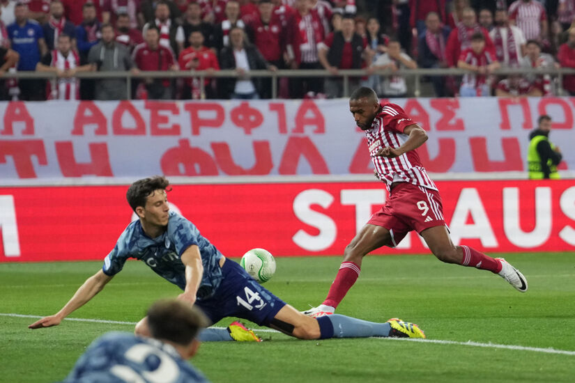 Ayoub El Kaabi of Olympiakos scores his team's first goal whilst under pressure from Pau Torres of Aston Villa during the UEFA Europa Conference League 2023/24 Semi-Final second leg match on 9 May 2024