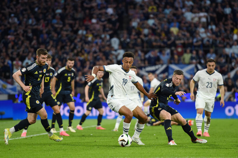 Dan Ndoye of Switzerland controls the ball whilst under pressure from Callum McGregor of Scotland during the UEFA EURO 2024 group stage match between Scotland and Switzerland at Cologne Stadium on June 19, 2024 in Cologne