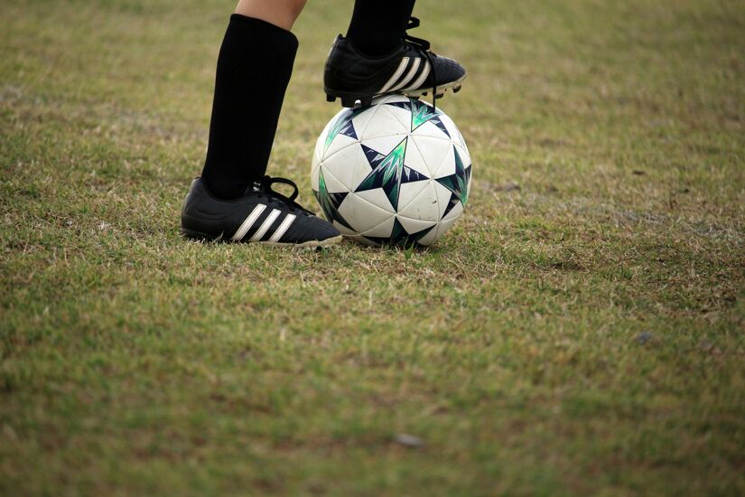 Football Black boots standing on ball