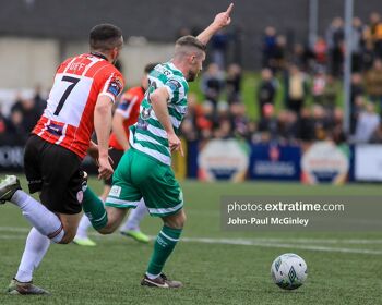 Jack Byrne points the way ahead of Derry City's Michael Duffy in the game in the Brandywell in May 2023 - Byrne scored both goals in the 2-0 win