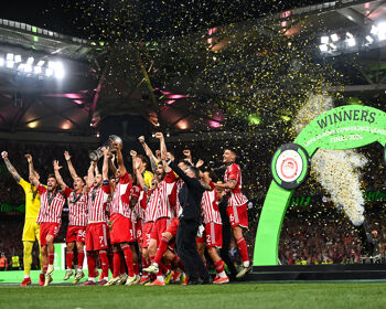 Olympiacos captain Konstantinos Fortounis lifts the UEFA Europa Conference League trophy alonside his teammates after the UEFA Europa Conference League 2023/24 Final match between Olympiacos FC and ACF Fiorentina at the AEK Arena on May 29, 2024 in Athens