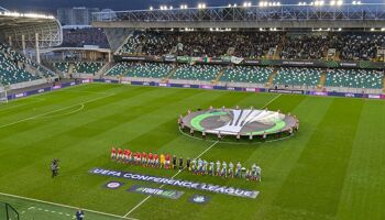 Larne and Shamrock Rovers line up before kick-off at Windsor Park