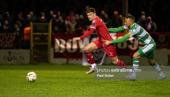 Sean Gannon is dragged back by Graham Burke in Shelbourne's 2-1 win over Shamrock Rovers last month