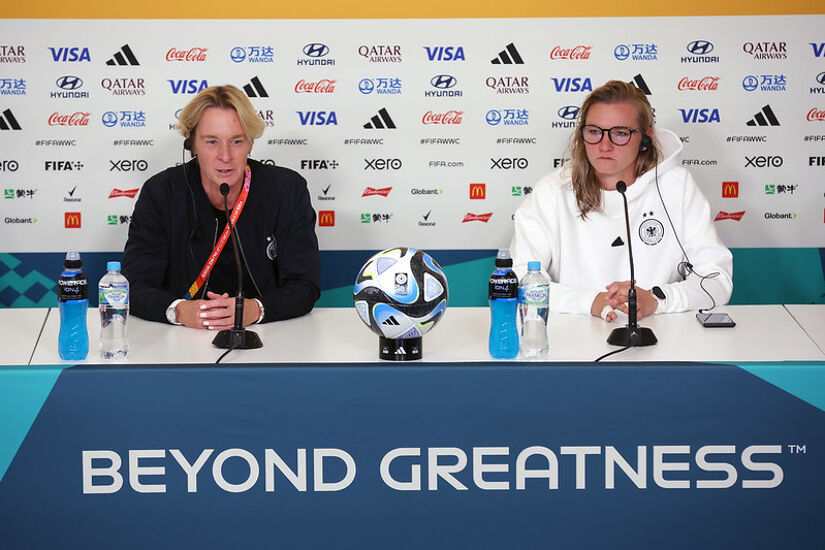 Martina Voss-Tecklenburg, Head Coach of Germany, and Alexandra Popp of Germany speak to the media in the post match press conference