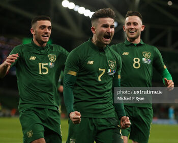 Sean Maguire celebrates after scoring against New Zealand with team-mates Troy Parrott and Alan Browne.