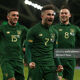Sean Maguire celebrates after scoring against New Zealand with team-mates Troy Parrott and Alan Browne.