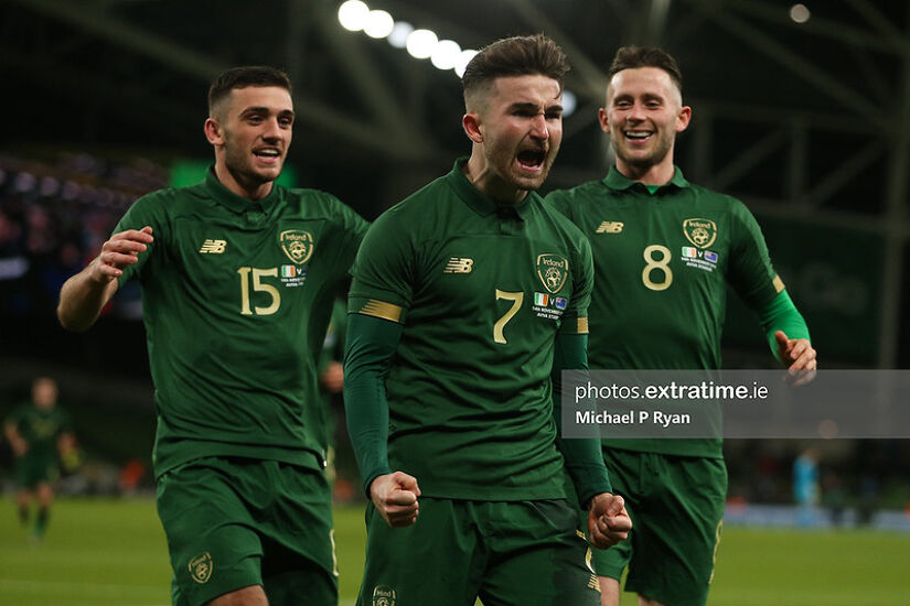 Sean Maguire celebrates after scoring against New Zealand with team-mates Troy Parrott and Alan Browne.