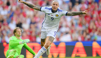 Lyndon Dykes of Scotland celebrates after scoring the team's first goal as Orjan Nyland of Norway looks dejected