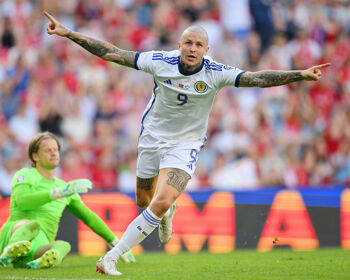 Lyndon Dykes of Scotland celebrates after scoring the team's first goal as Orjan Nyland of Norway looks dejected