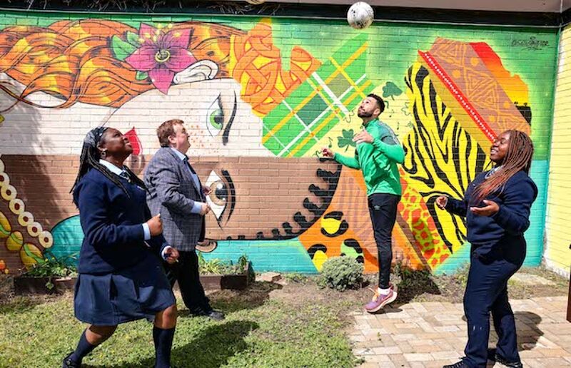  Colm Brophy TD, Shamrock Rovers defender Roberto Lopes and students Victoria Doyeni and Princess Ibrahim in front of a new mural highlighting the unique connection and unity between Africa and Ireland which was unveiled at Old Bawn Community School 